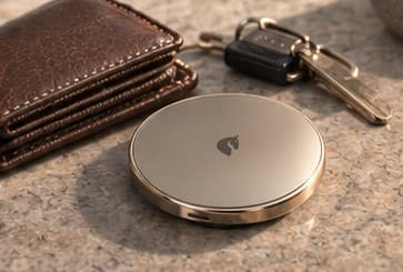 The Aresto AI Wallet on a table next to a leather wallet and keys